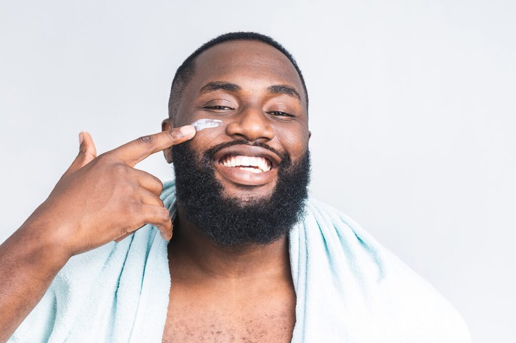 Man applying primer to face